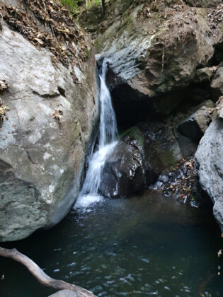 Small waterfall between rocky cliffs